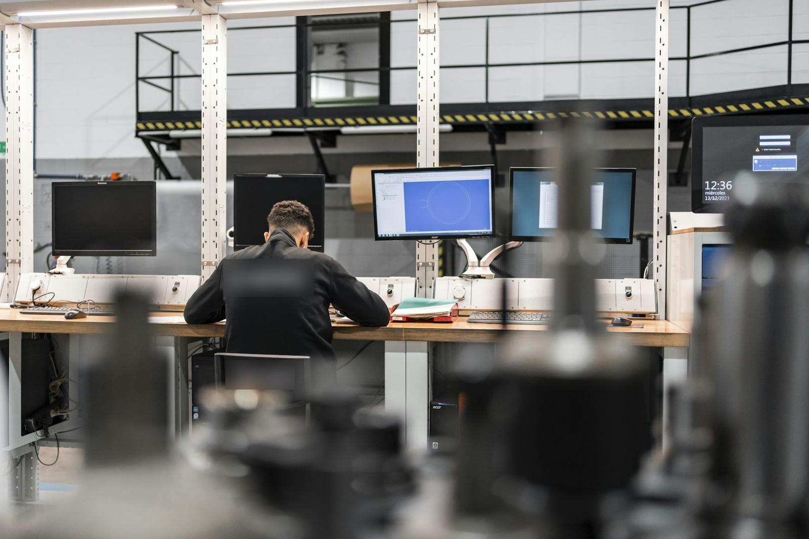 Engineer reviewing a design at CAD workstations