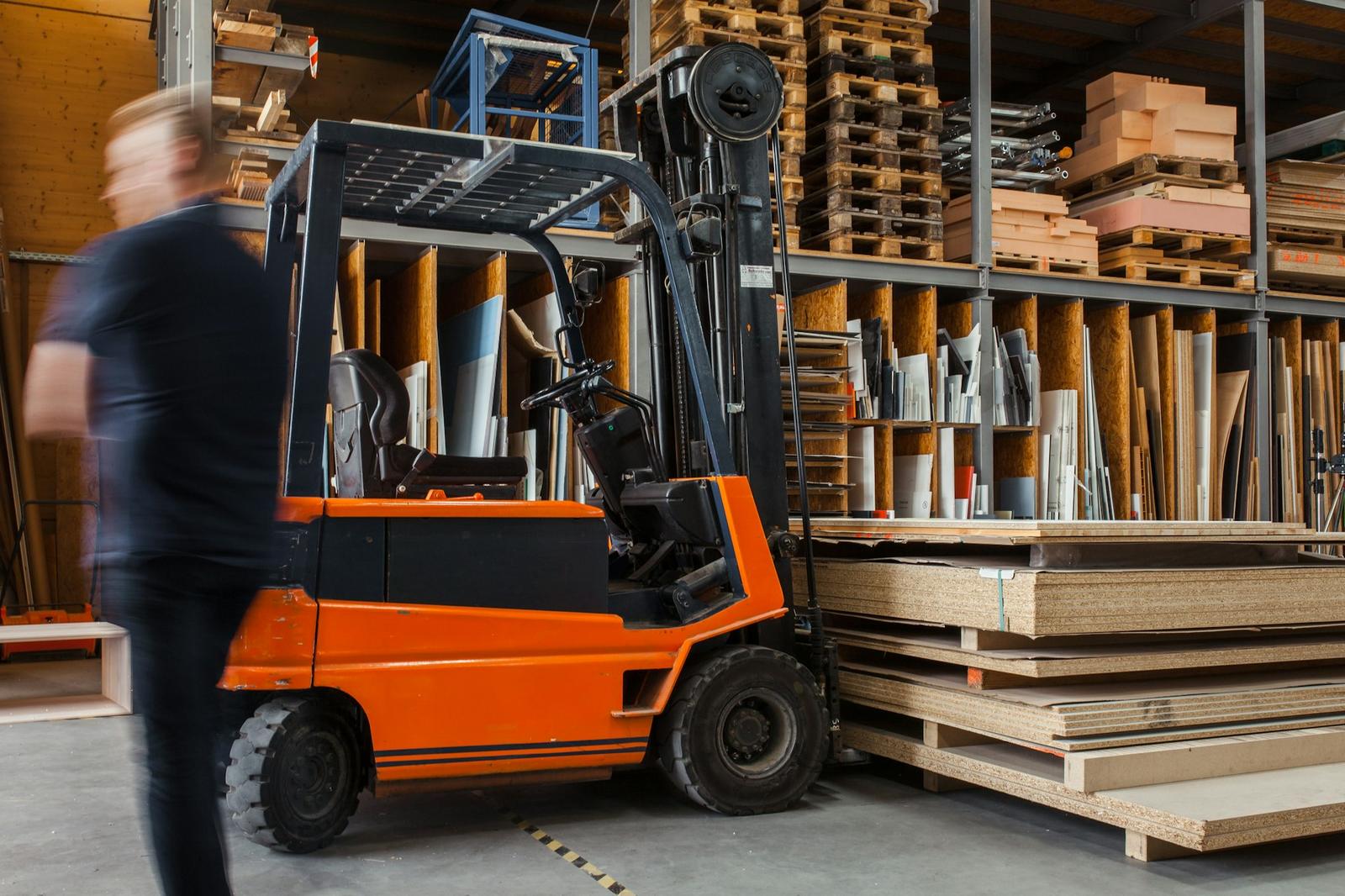 Forklift moving palletised stock in the warehouse